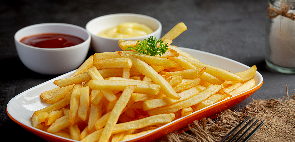 Crispy French fries with ketchup and mayonnaise.